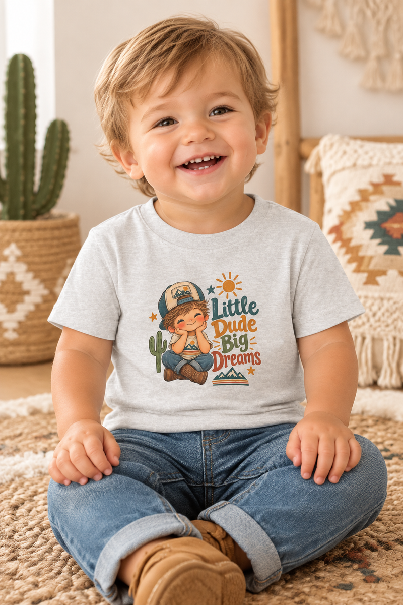 Little boy wearing a Little Dude Big Dreams infant T-shirt